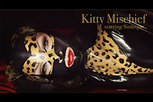 In the third of the Sinteque videos by Mark Esper, Sinteque is Kitty Mischief, caught with the cream in her HW-Design leopard-print latex catwoman suit 