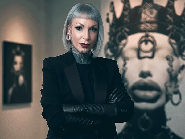 DUTCH ARTIST Leila Lovit poses with two of her distinctive AI creations in the background (image: Leila Lovit)